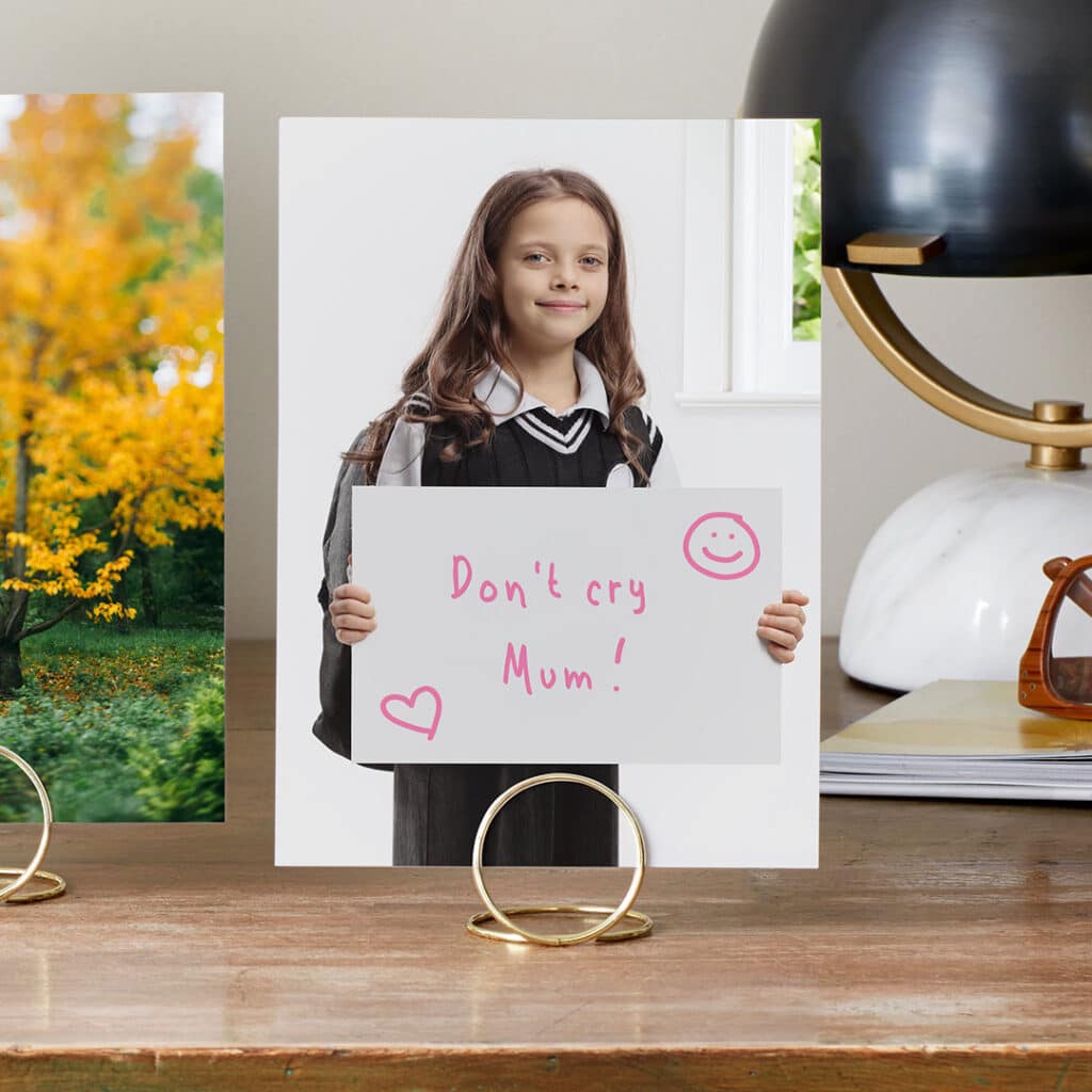 Capture and print a portrait of your child on the first day of school with a funny sign for Mum or Dad.
