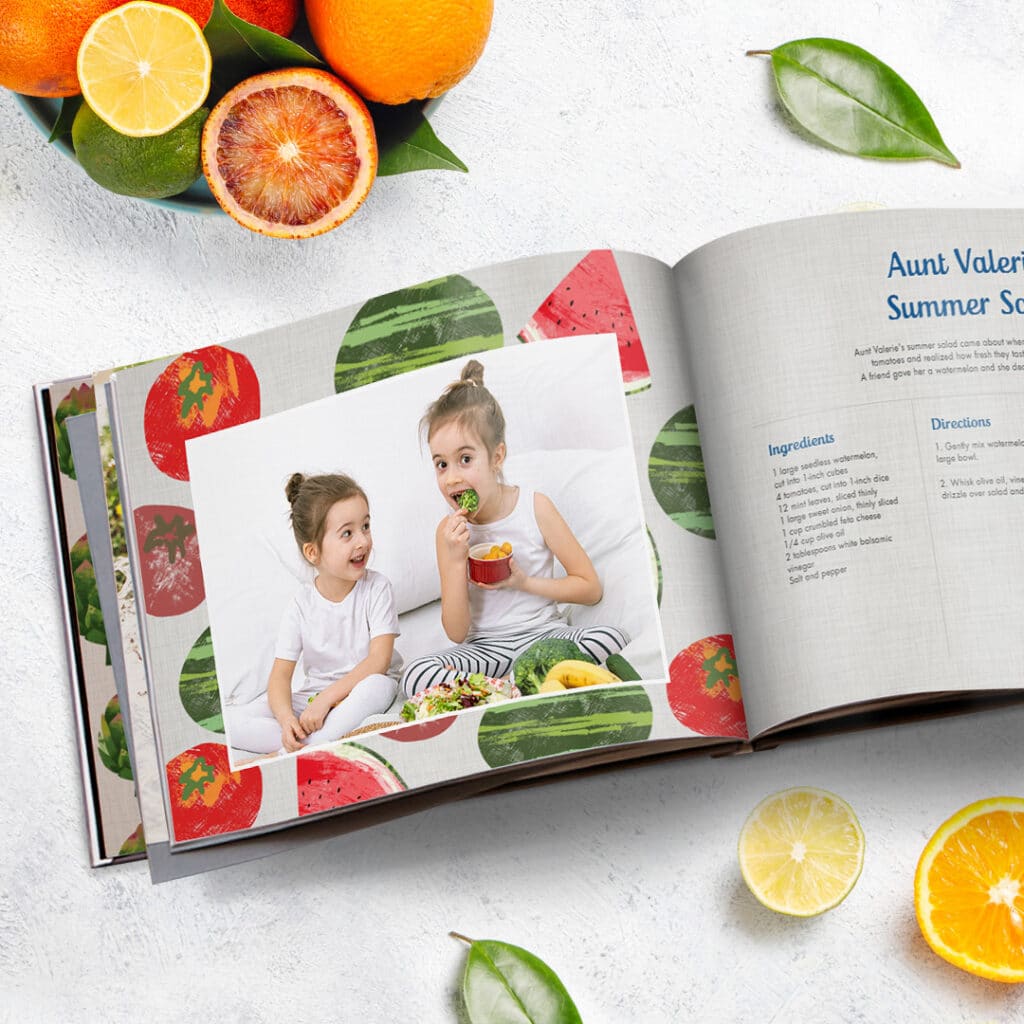 A summer recipe photo book with an image of two little girls eating colourful vegetables