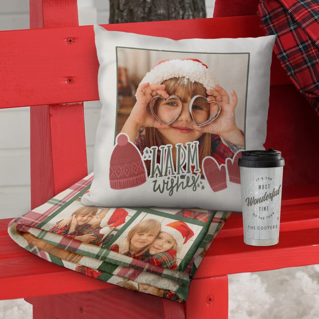 a personalised blanket and a custom cushion on an outdoor red bench