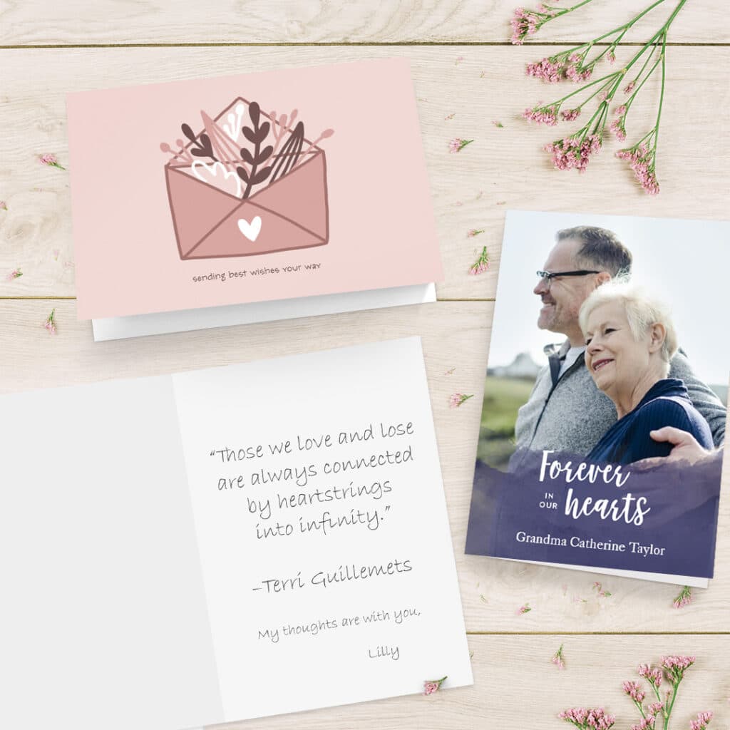 A collection of sympathy cards shown on a surface with beautiful pink flowers