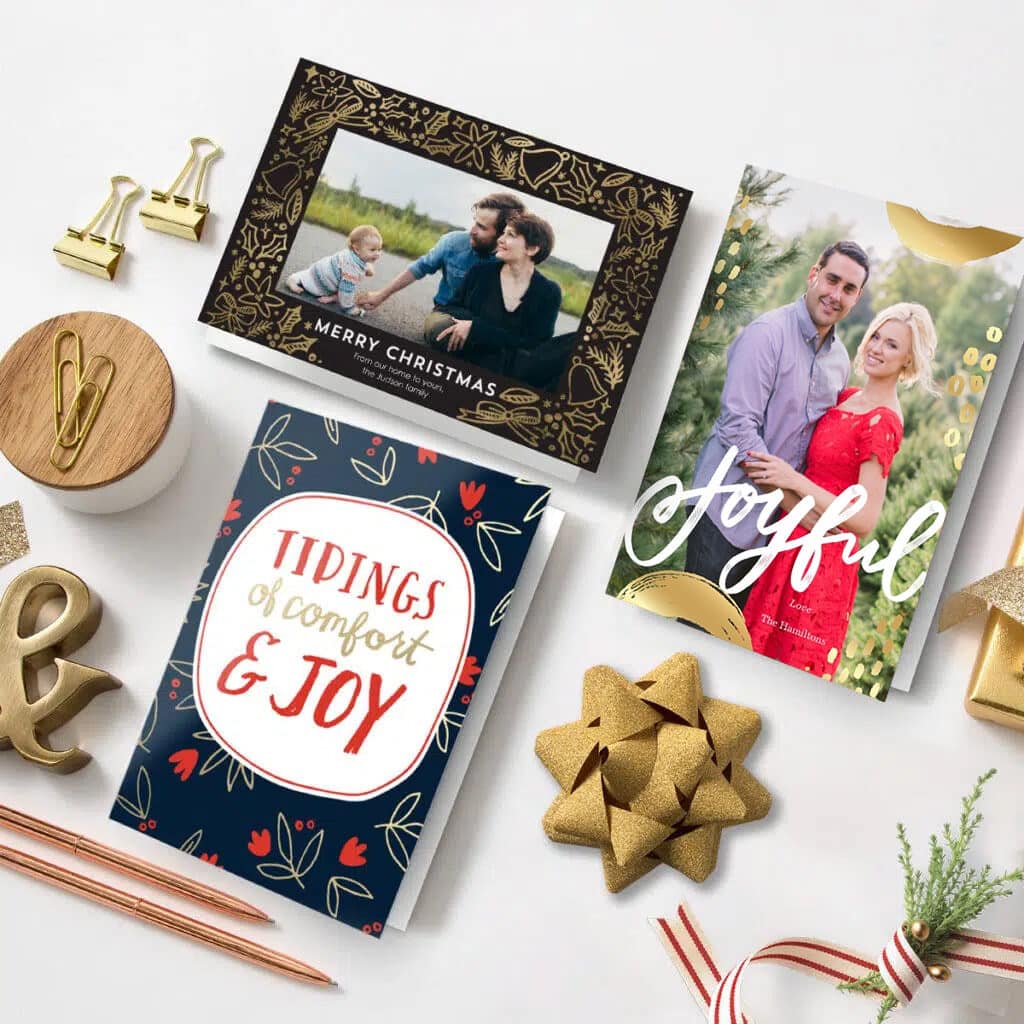 Christmas Greeting Cards displayed with various props on a table