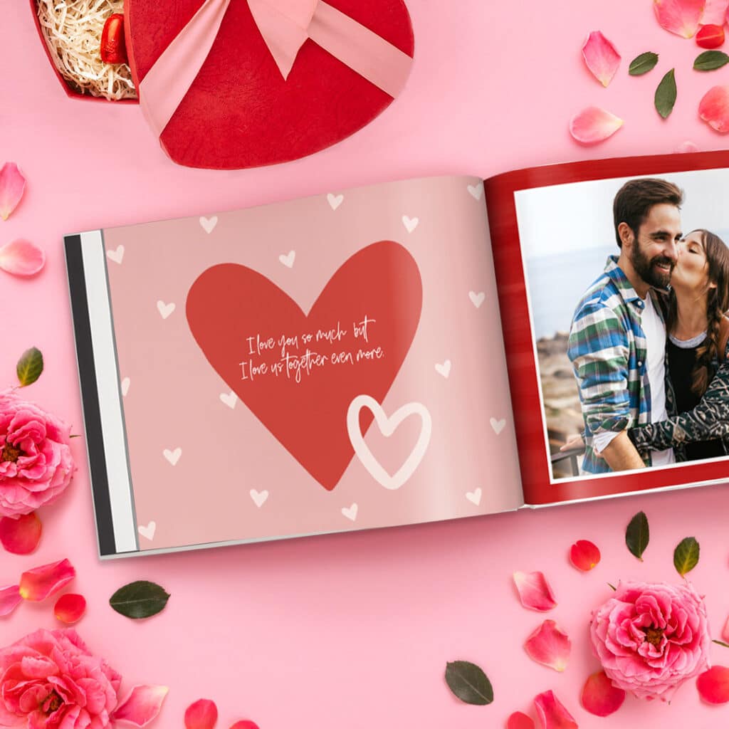 Open Valentine's photo book beside a gift and flowers