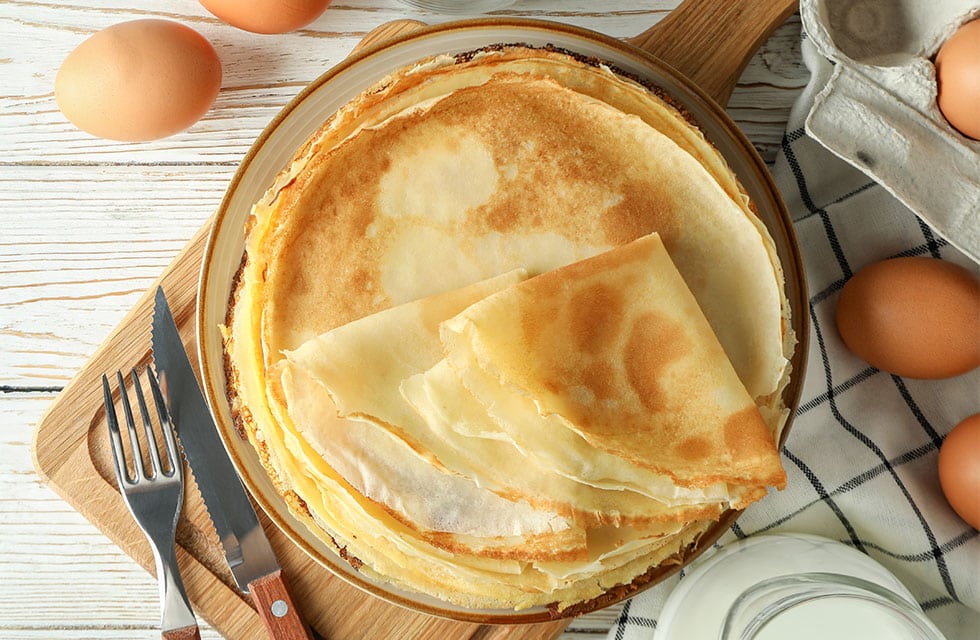 Birdseye view of pancakes stacked up on a plate