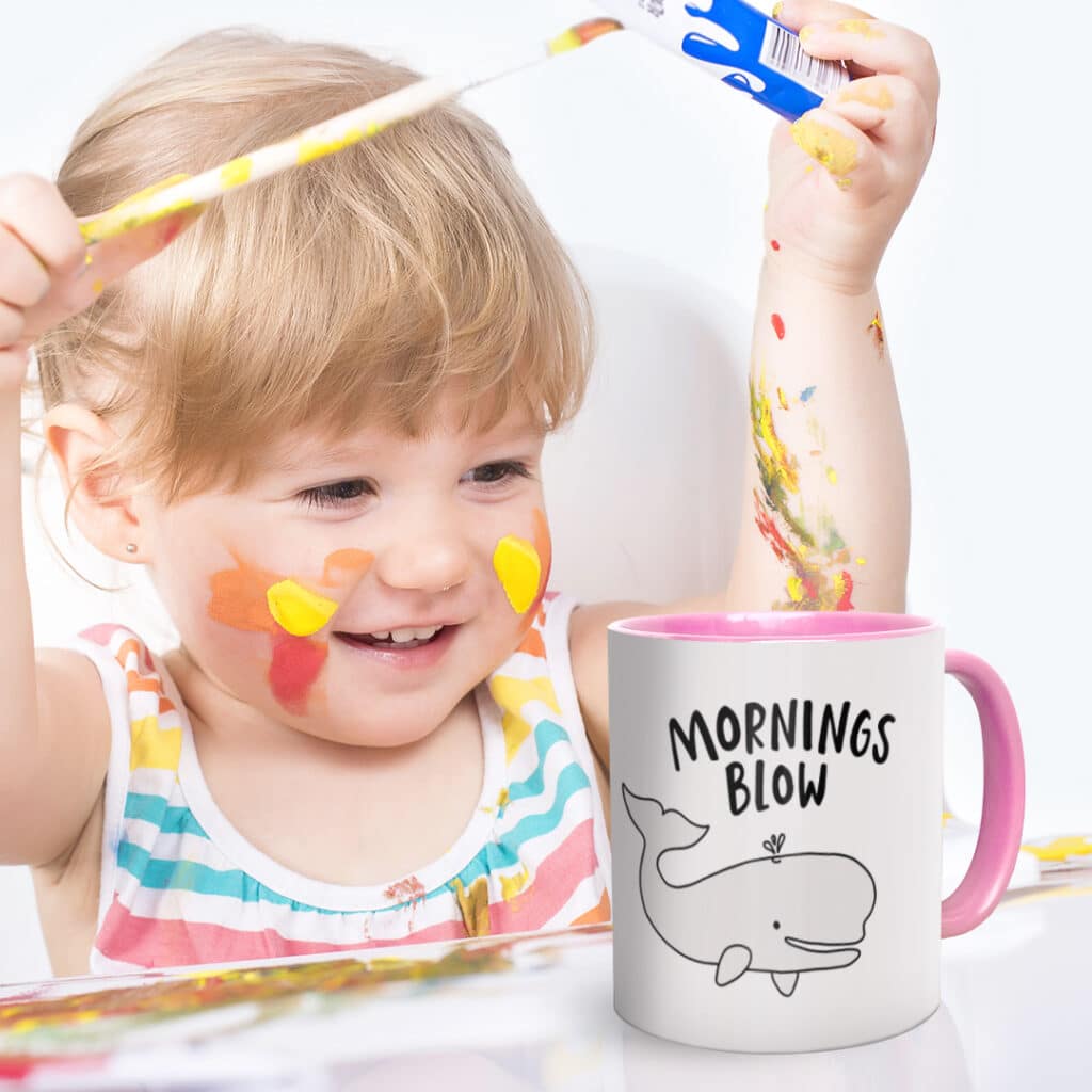 A child painting her custom personalised mug