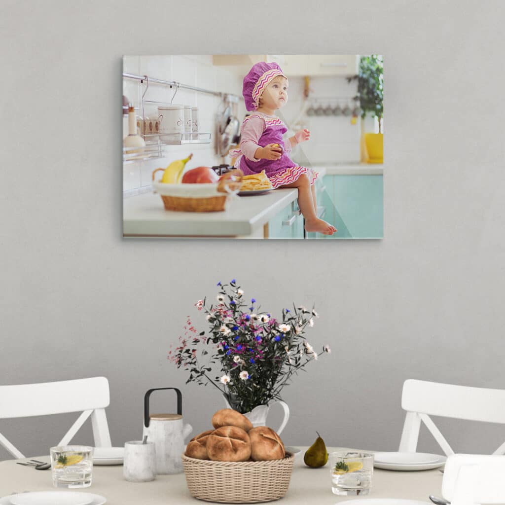 An acrylic photo print hanging above a dining table